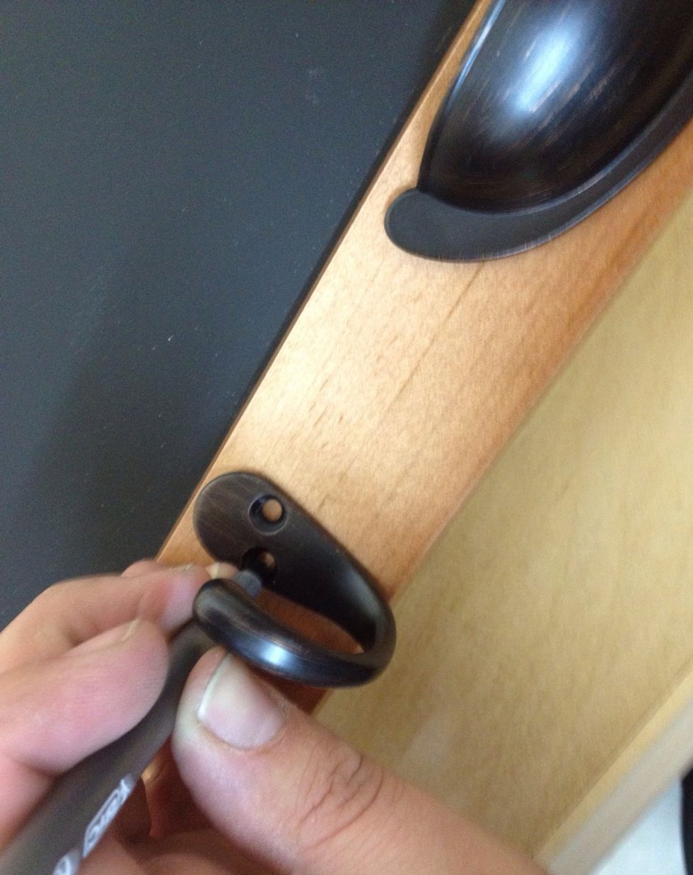 Mark the holes for the hooks. Unless you are using more than 2 hooks, there is no need to measure - just eyeball it. Tip: Avoid drilling any holes at the "seams" of the frame as this will weaken it.