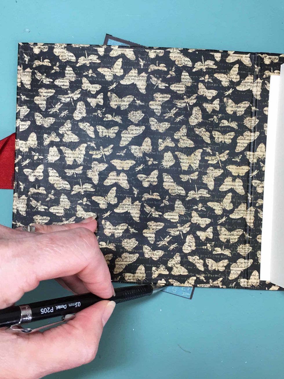 Mark the part of the frame that hangs over the edge of the mini and then cut the extra off. Then adhere the frame in place.