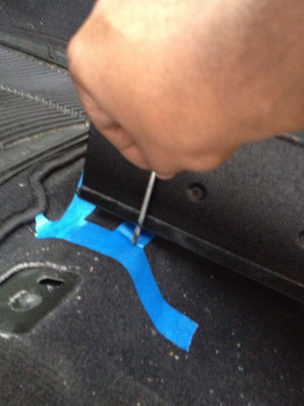 Marking the holes to mount it to the floor