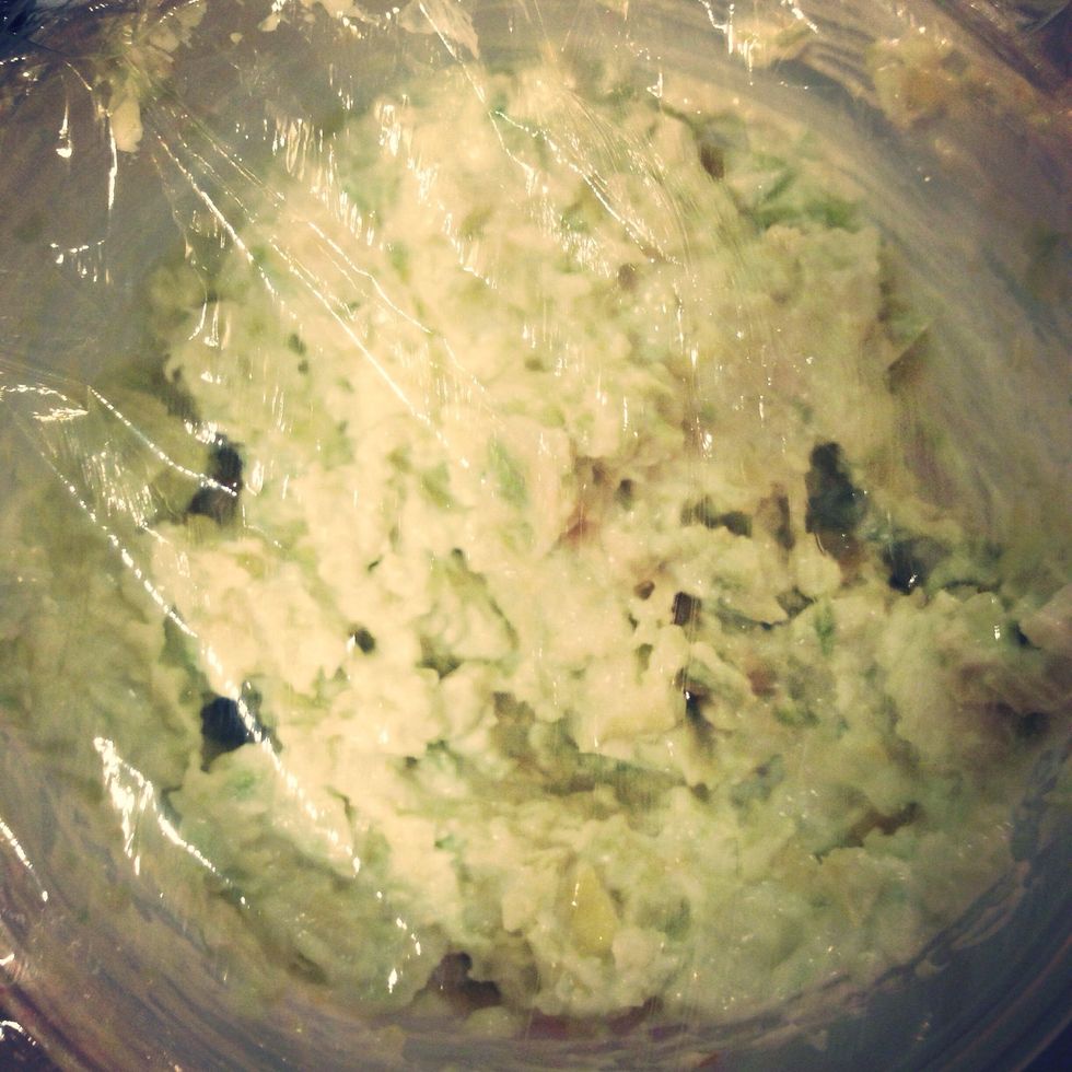 Mash avocado with fork, add garlic paste, lime, basil and quark/greek yogurt. Put in the refrigerator in a plastic container with lid/plastic.