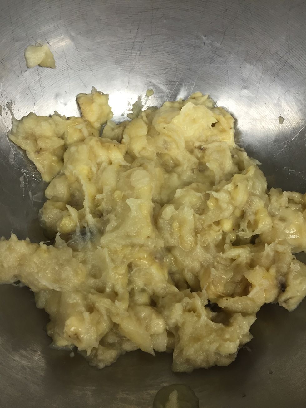 Mash steam bananas in a mixing bowl making sure to leave a few chunks.