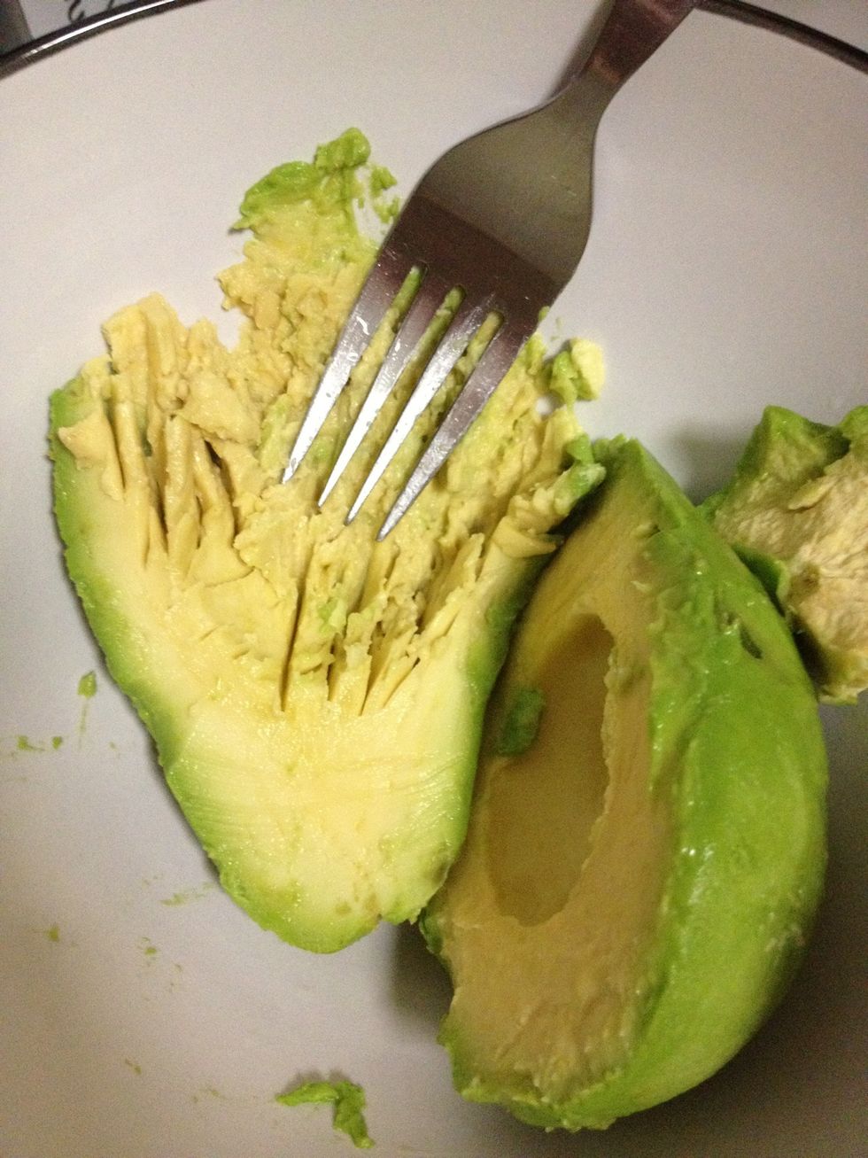Mash the avocado in a bowl.