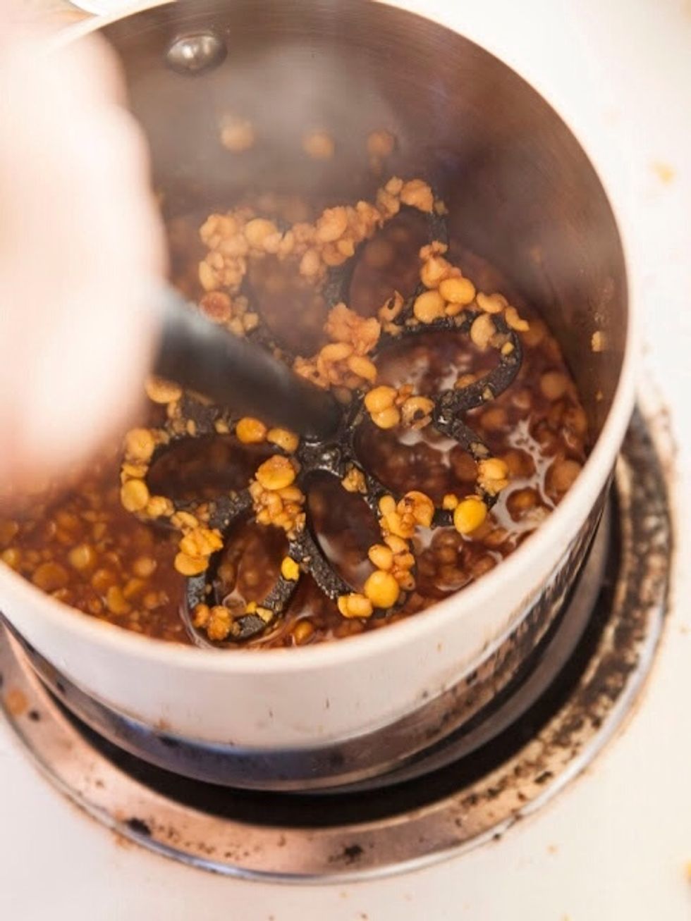 Mash the dal into the syrup.