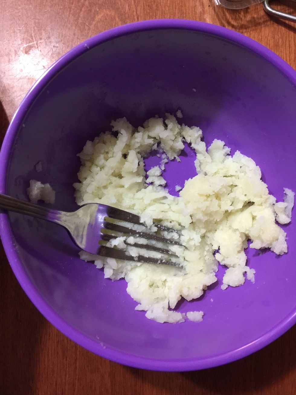 Mash the potatoes with a fork