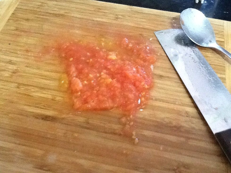 Mash the tomatoes with a knife.