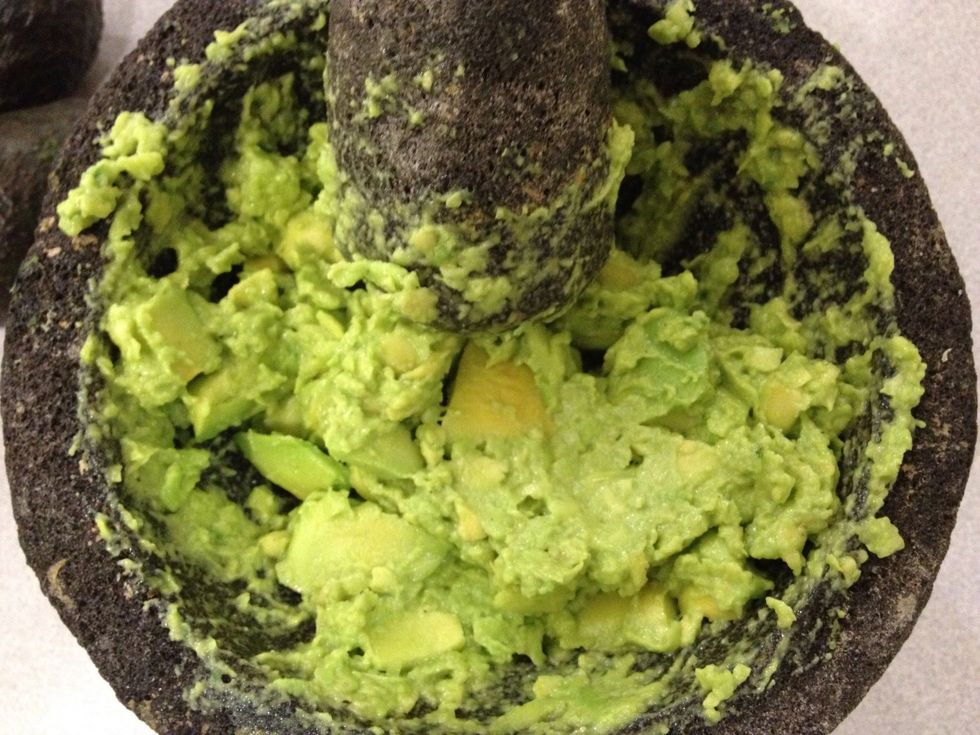 Mash until avocado starts to turn into a paste, leaving some chunks.