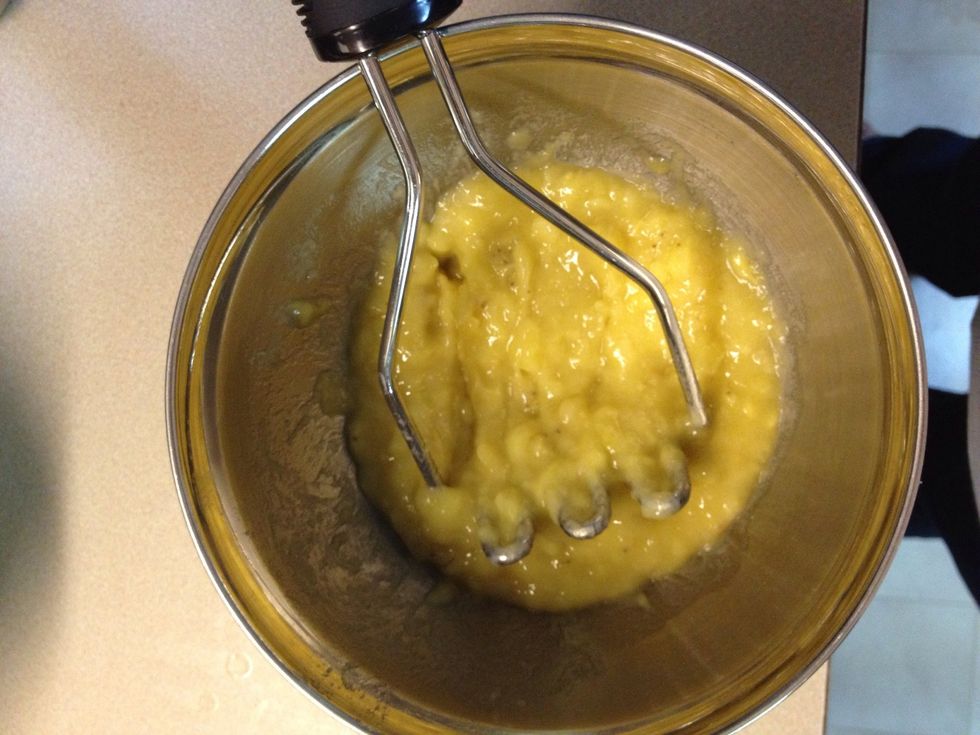 Mash your overripe bananas with a potato masher or a fork.