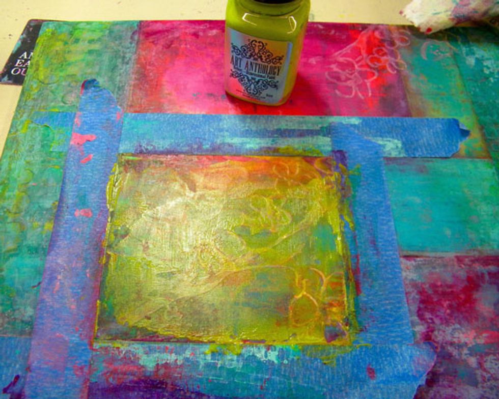 Mask off the boxes with the Blossom stencil and add more color to the top, scraping it off or using a baby wipe for a more subtle look. By adding and removing paint, you add depth to the painting.