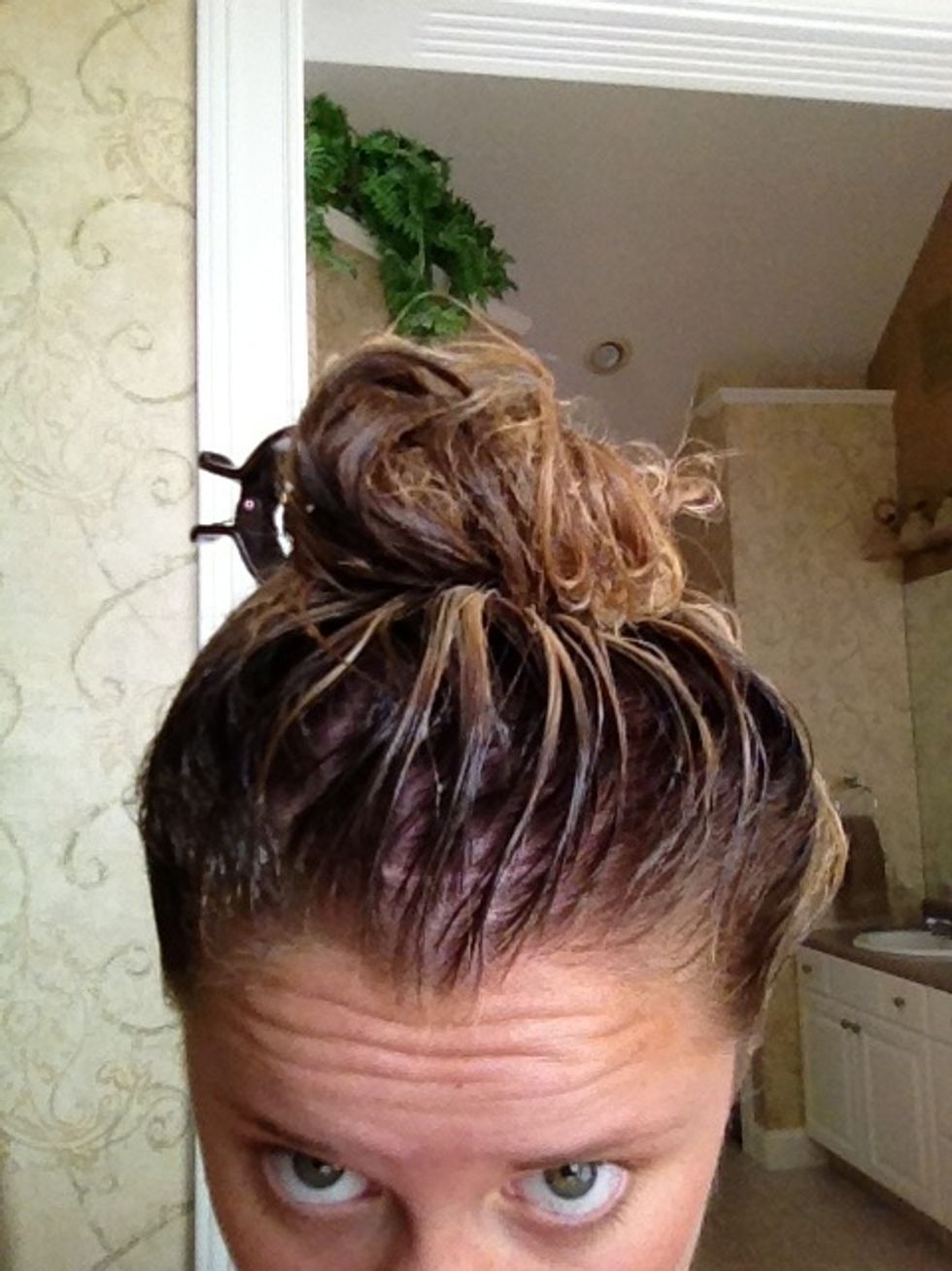 Massage it through your locks using your fingers. A wide-toothed comb works as well!