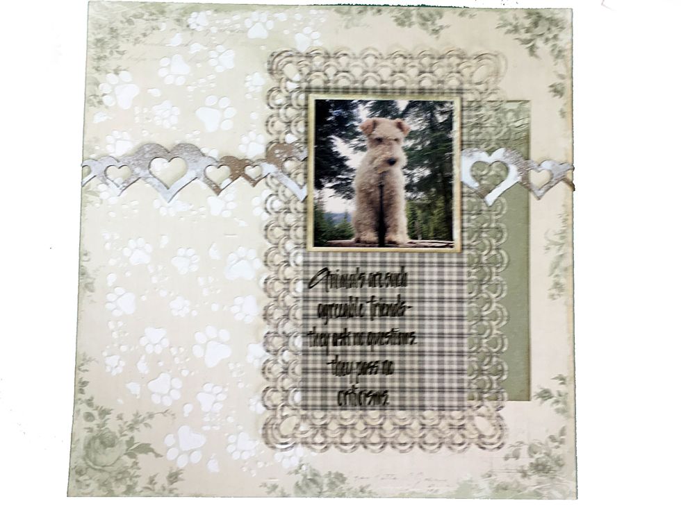 Mat the photo with a scrap from Handsome and then use cardboard or foam tape to pop up the photo. Fit the heart border beside the photo.