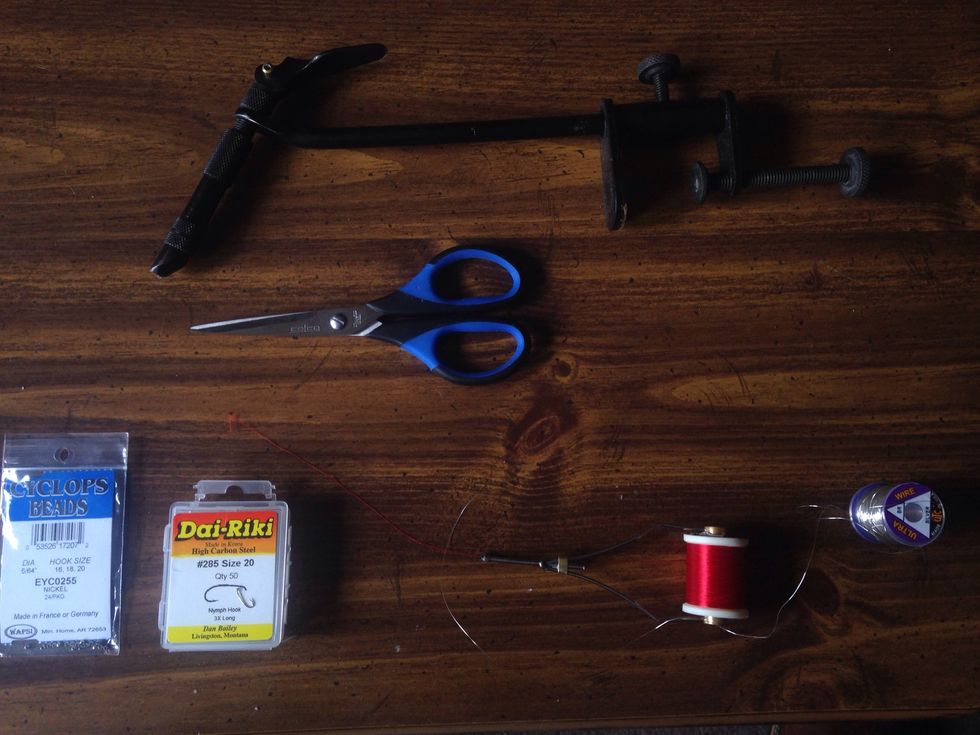 Materials needed: -Vise -Dai-Riki #285 size 20 hooks -5/64" cyclops bead heads - 2/0 red thread -silver fly tying wire - scissors