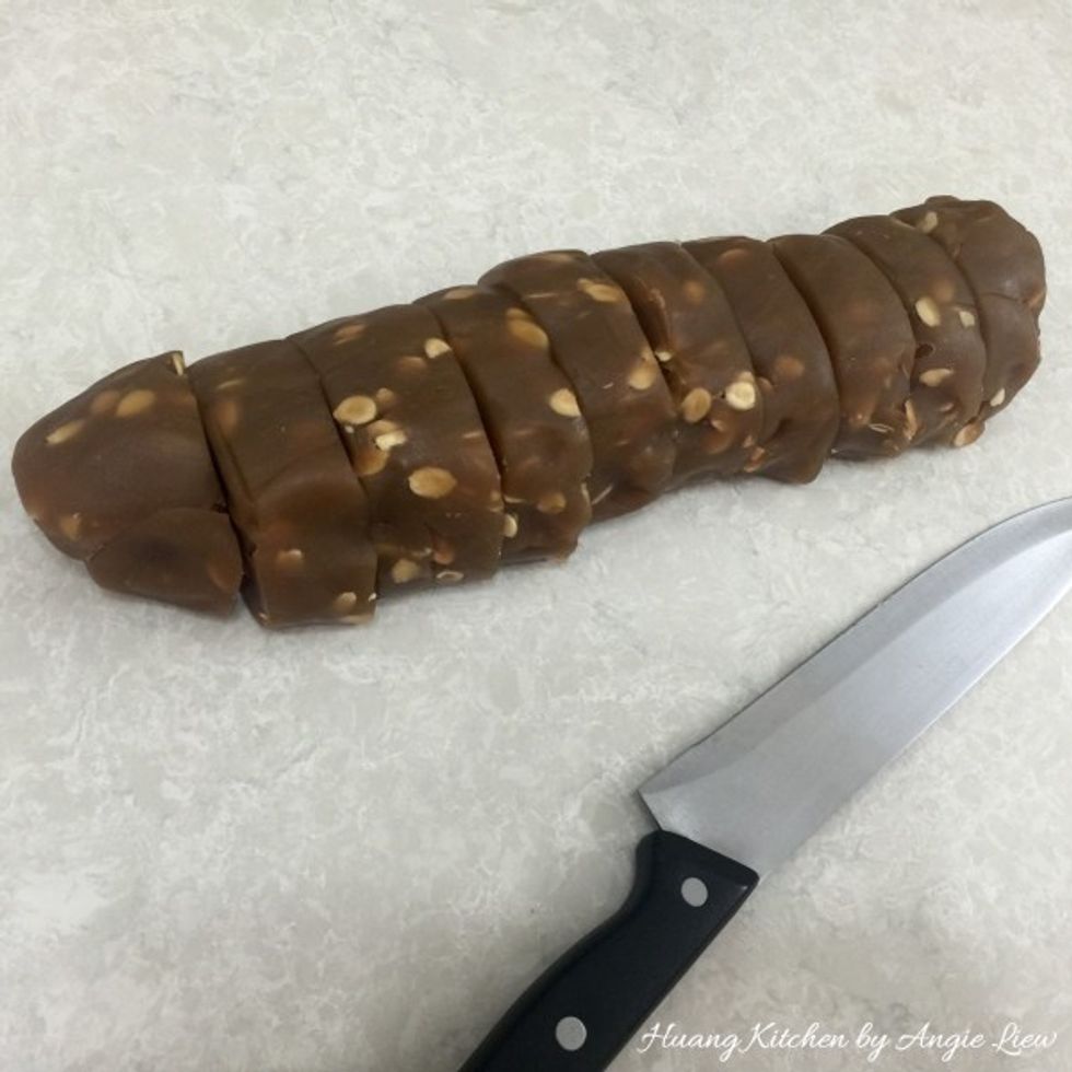 Meantime, prepare the fillings. Mix lotus seed paste with the toasted melon seeds till well combined. Then roll into a long log. Using a sharp knife, cut the lotus paste filling into 10 equal pieces.