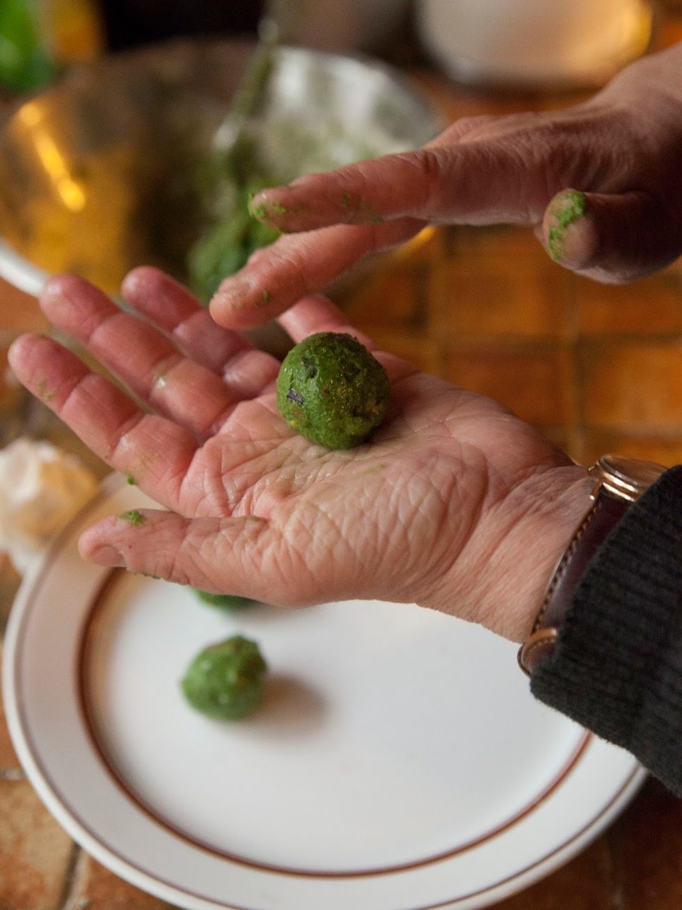 Meanwhile, back at the nettles or spinach. Take a teaspoon of the mixture, dampen your hands and roll the mixture into a ball.