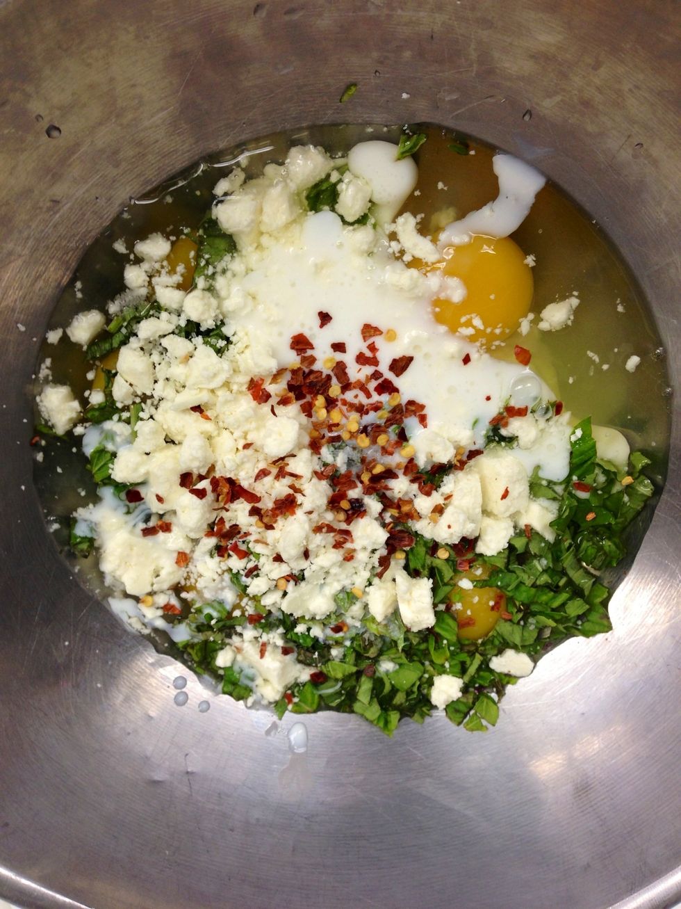 Meanwhile, combine the eggs, buttermilk, basil, feta, salt, and pepper flakes.