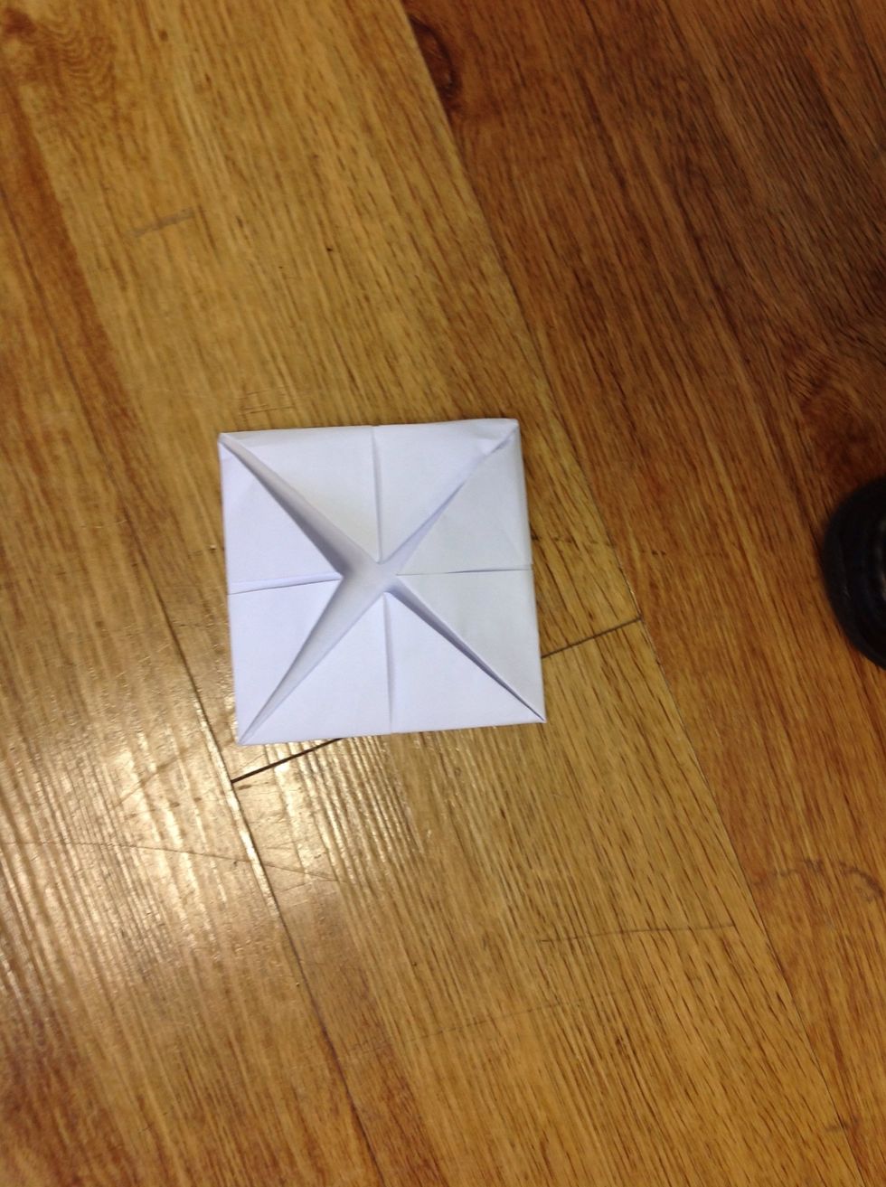 Meanwhile,fold 4 corners in the middle of paper again.