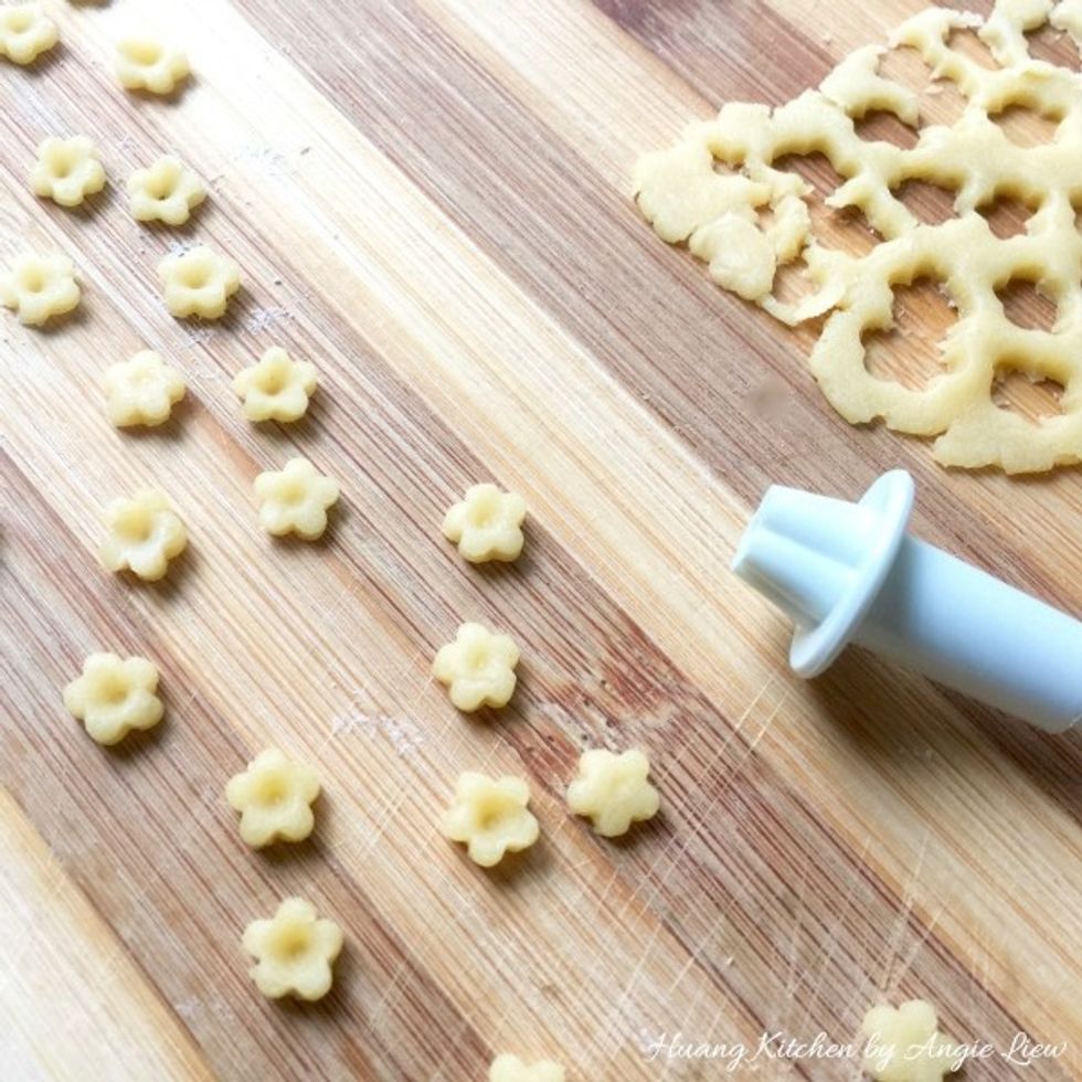 Meanwhile, gather the leftover pastry dough and roll to flatten it. Using a fondant cutter, cut mini flower shapes to be put on top of the pineapple jam. Set aside for later use.