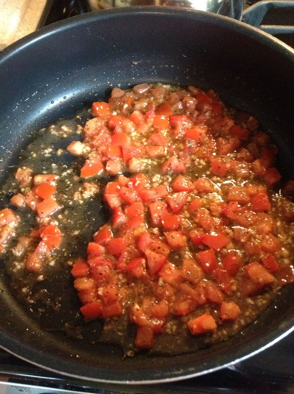 Meanwhile, heat 3 tbspn's olive oil. Add remaining garlic. Cook until fragrant (about one minute or so). Do Not Burn Garlic!!! Add tomatoes, basil, salt, pepper, and a splash of lemon juice.