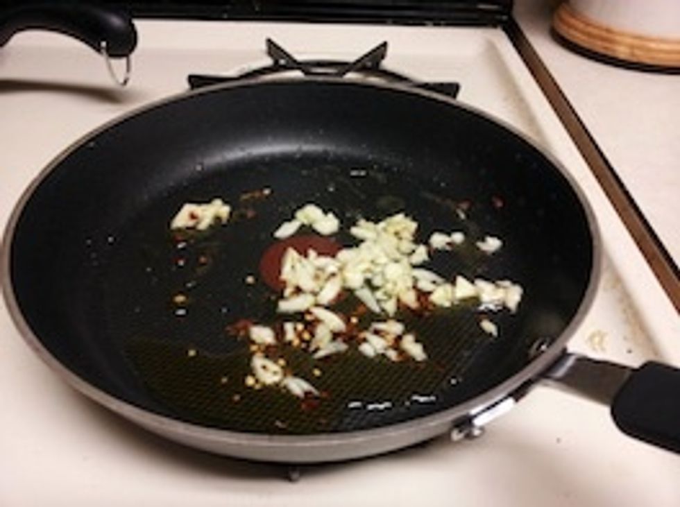 Meanwhile, heat the olive oil in a large skillet over medium heat. Add the garlic and red pepper flakes and cook, stirring, until slightly toasted, 1 to 2 minutes.