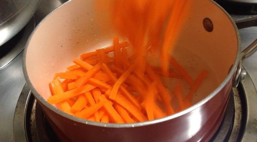 Meanwhile, let's prepare the toppings. Heat up 2 tbs of canola oil and add the carrots (cut into thin strips)