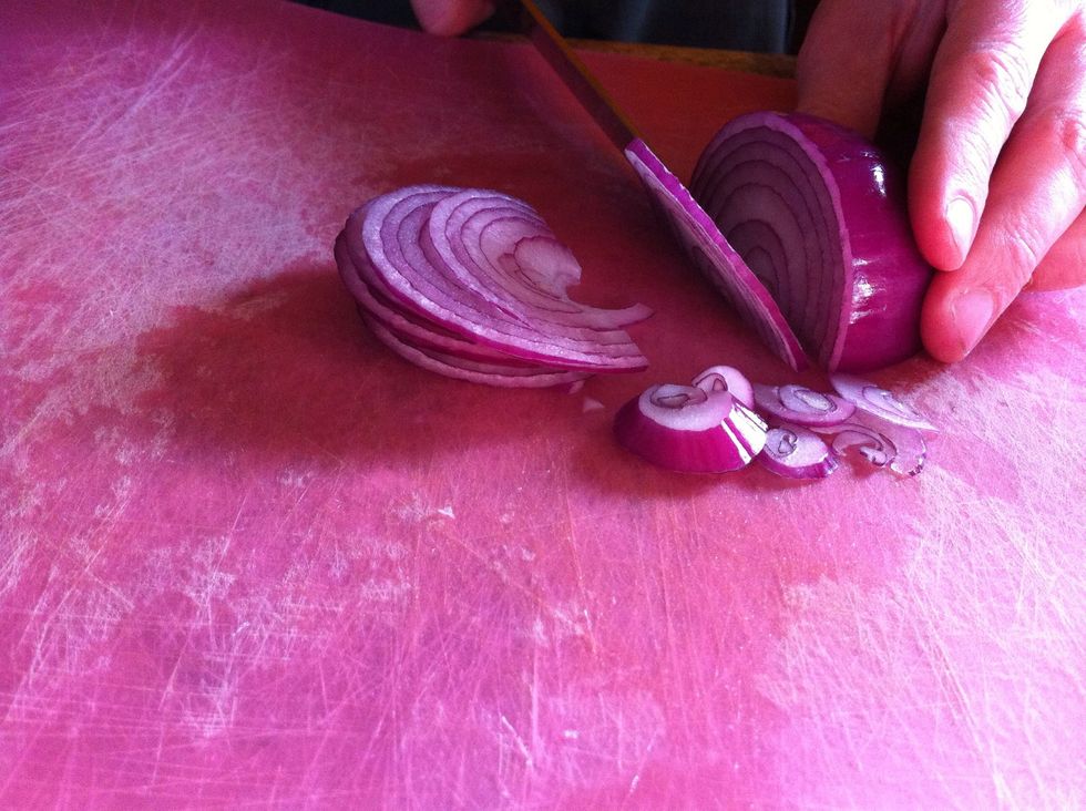 Meanwhile, make the onion sauce by thinly slicing the red onion into rings. You can use any kind of onion you'd like. I prefer red for the color it adds to the dish.