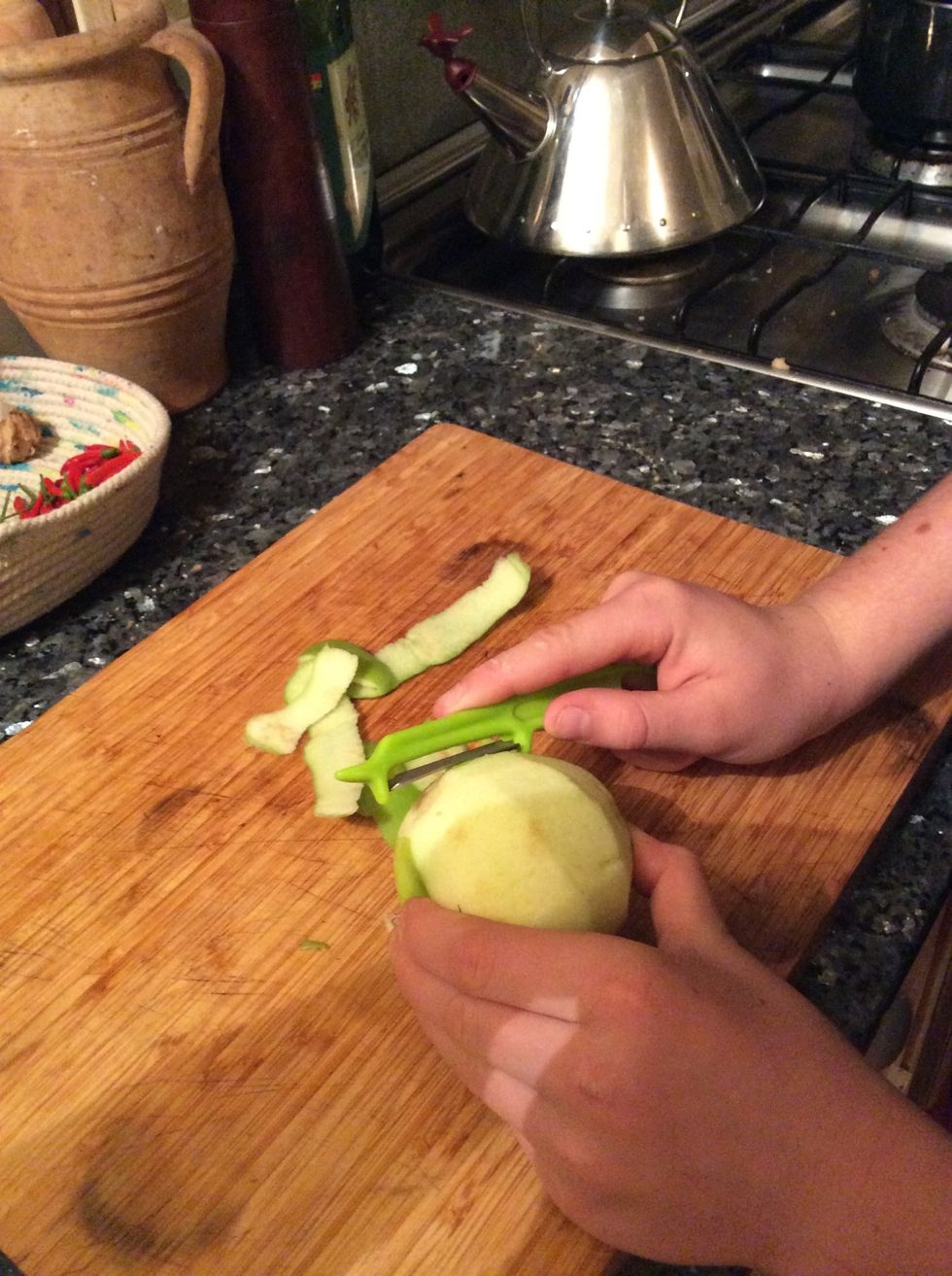 Meanwhile, peel and quarter the 3 apples.