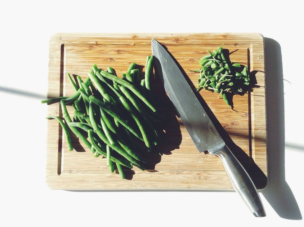 Meanwhile, prep your green beans by washing and trimming off the ends.