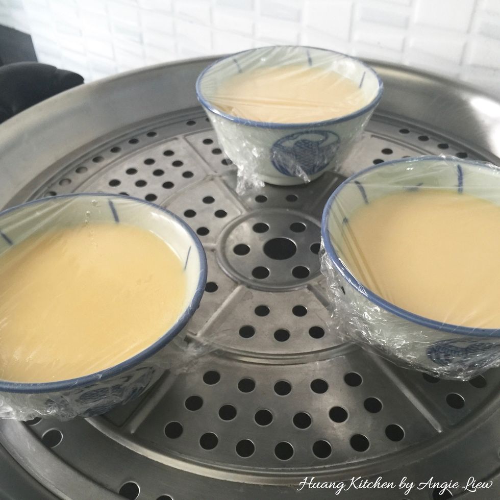 Meanwhile prepare steamer by bringing water to a boil. Place the steaming bowls onto steamer.