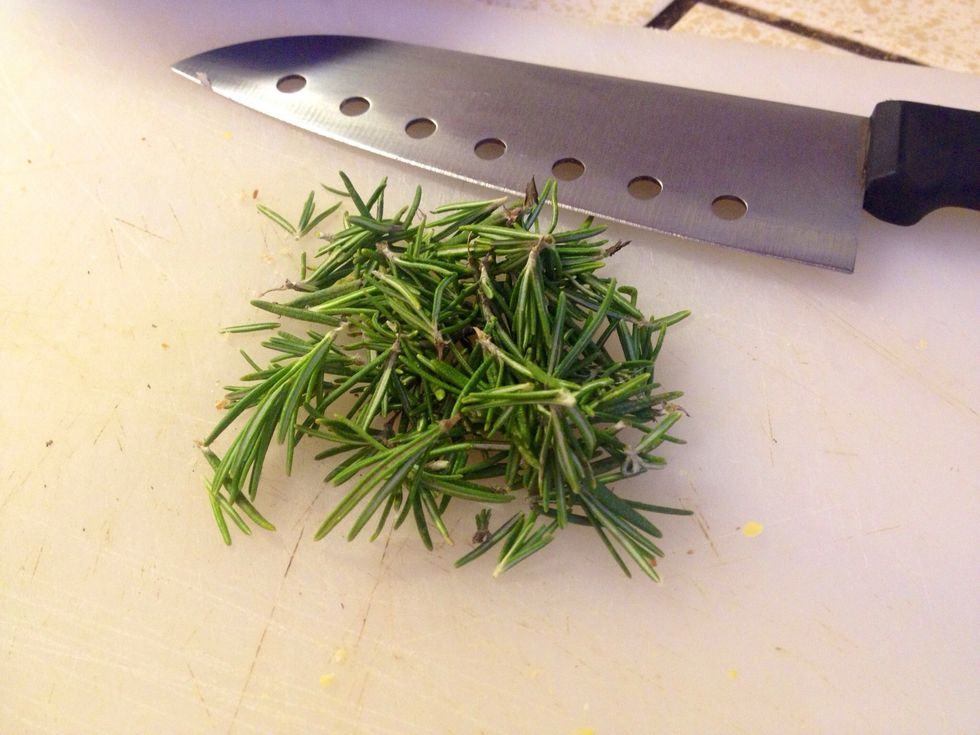 Meanwhile, pull the rosemary leaves from the sprigs and onto a cutting board.