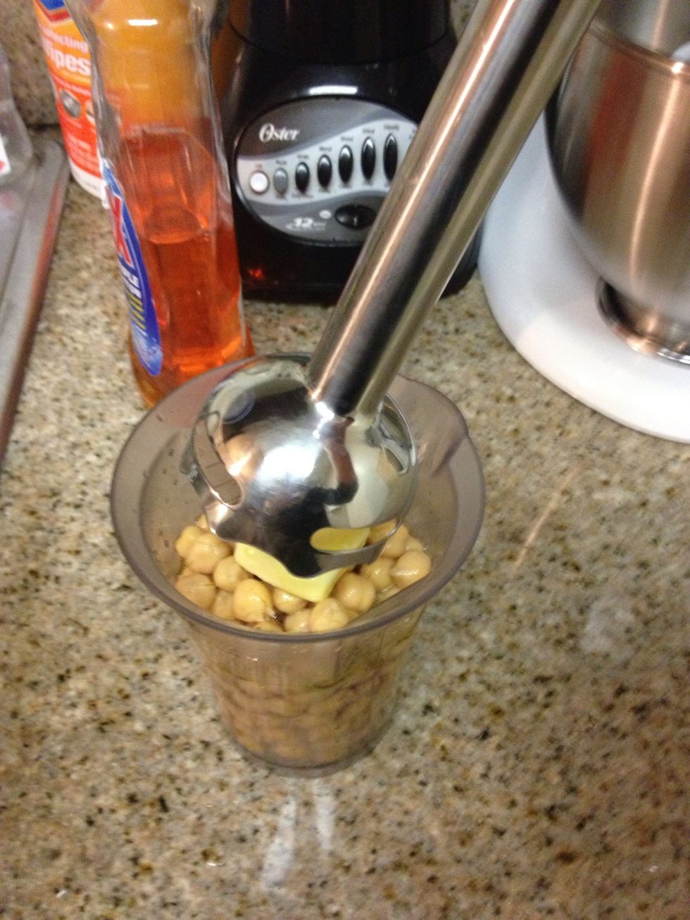 Meanwhile pur\u00e9e a can of drained and rinsed chickpeas, water ,olive oil, lemon juice, and garlic.