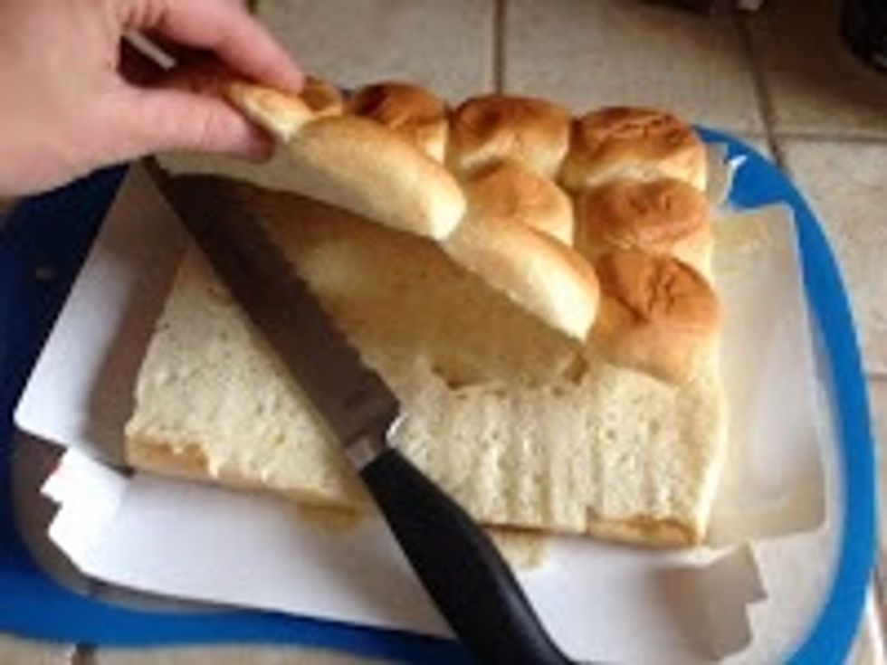 Meanwhile, slice buns so that the bottoms and the tops stay intact.  Place bottoms in a baking dish.