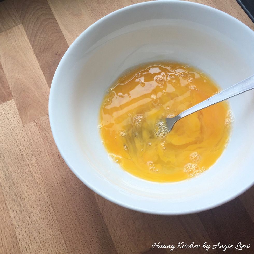 Meanwhile, using a fork, beat the eggs gently but thoroughly. Do not use an electric mixer as this will create too much foams or bubbles which will prevent the surface of pudding from being smooth.