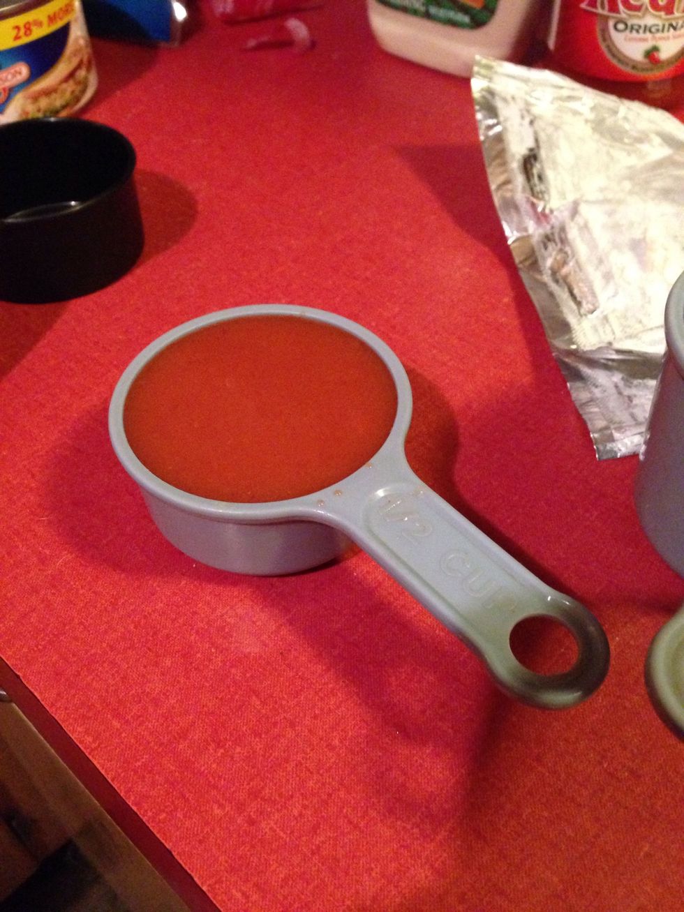 Measure 1/2 a cup of hot sauce and add to the pan.