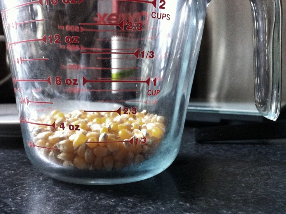Measure 1/3 cup of popcorn kernels.