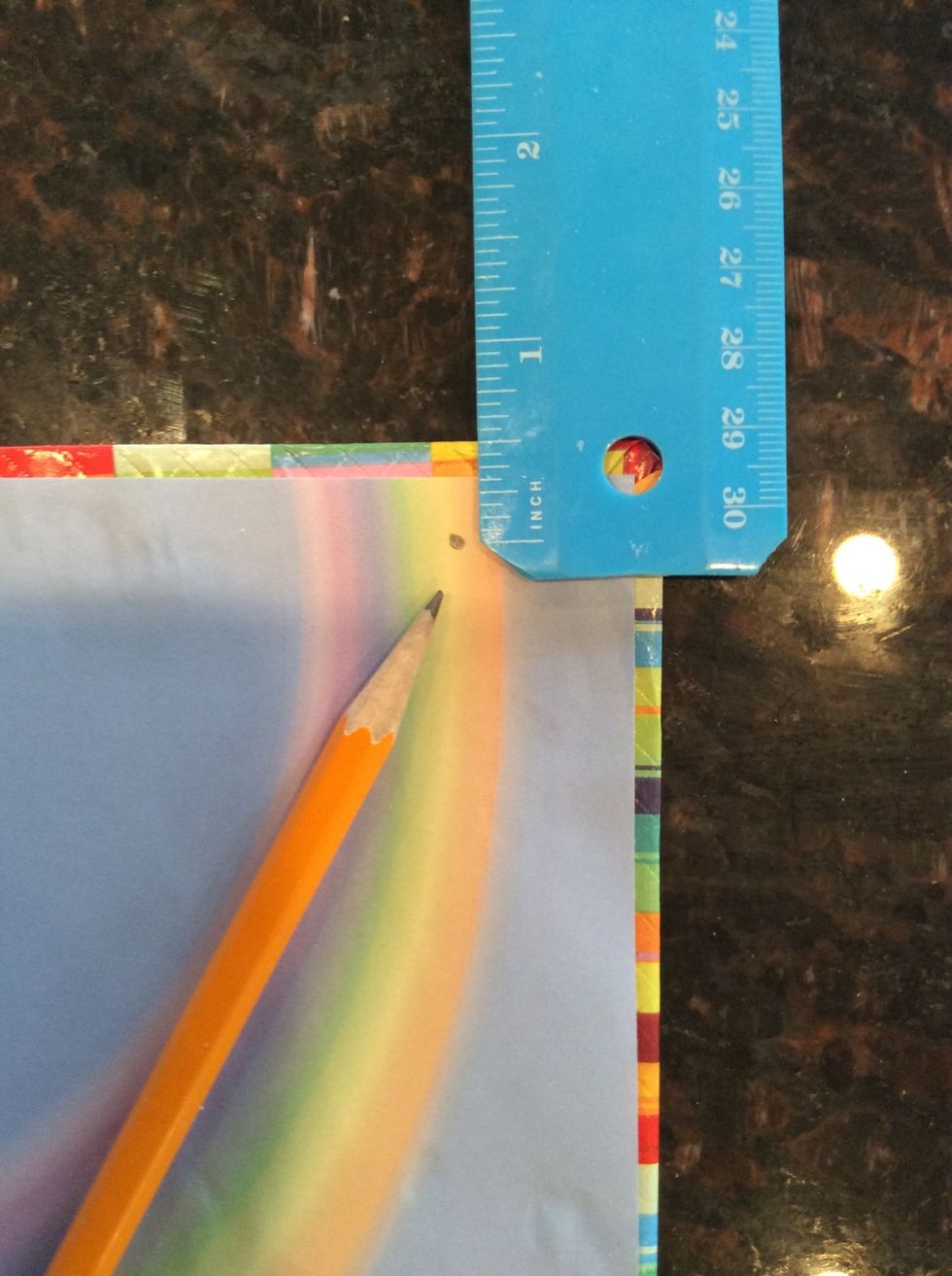 Measure 1 inch down from top and 1/2 inch from the side and punch a hole. Repeat at the bottom. Repeat for the other piece of chipboard.