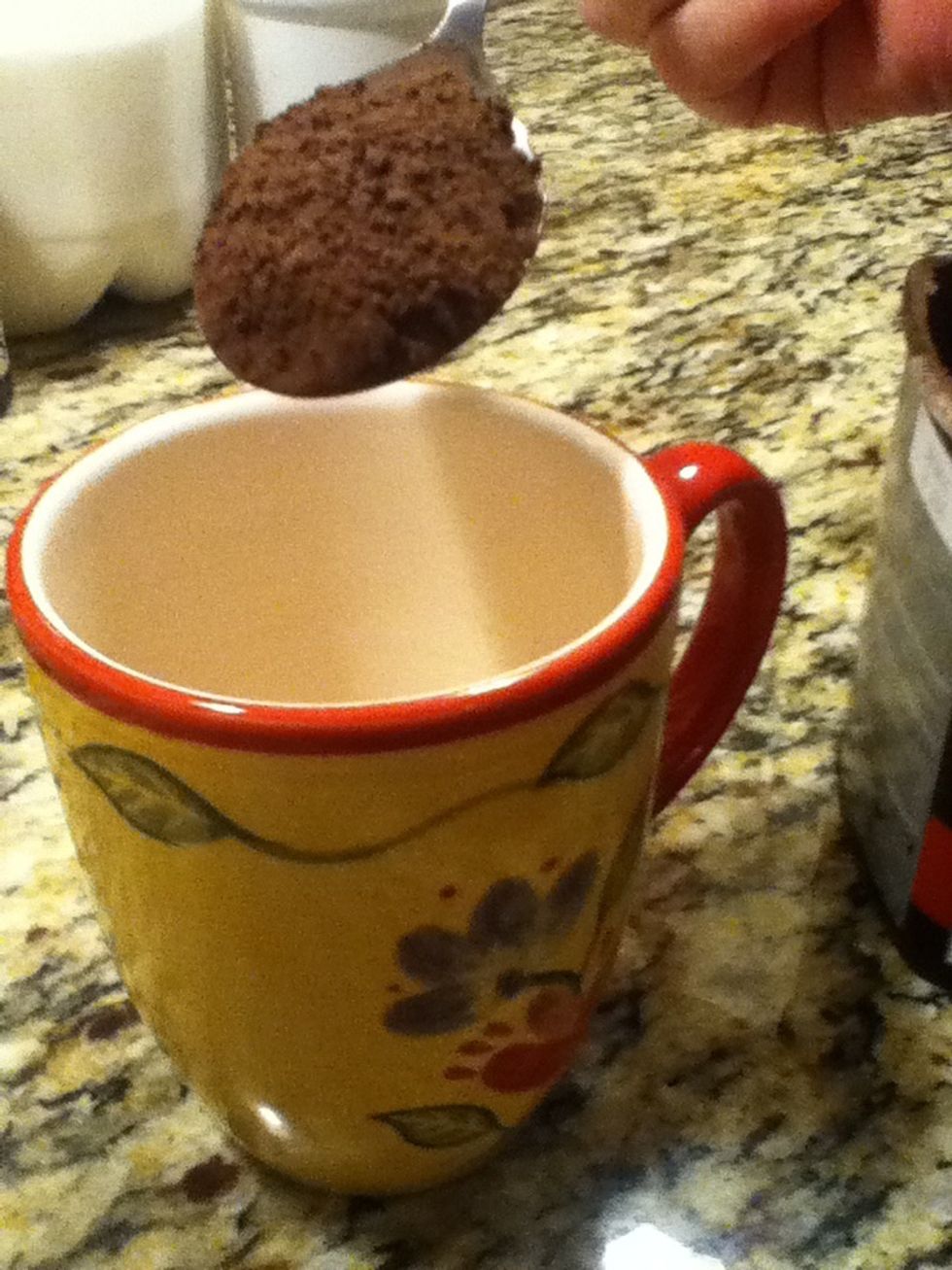Measure 2 tablespoons of cocoa and put into mug