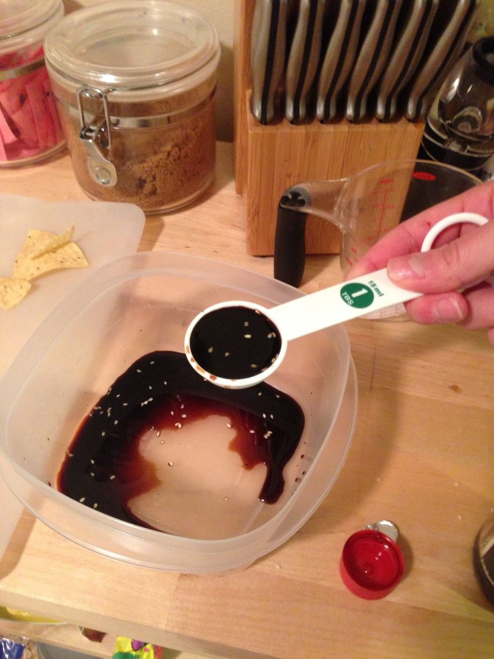 Measure 2 Tbsp of soy sauce in a container. I added a bit of sesame seeds for flavor.