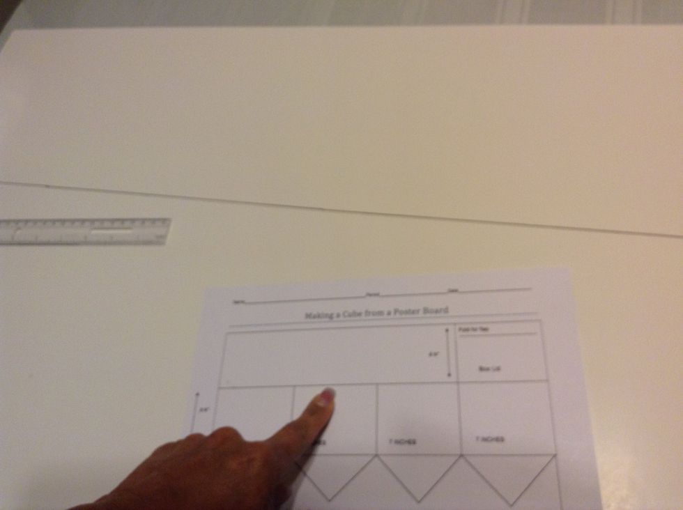 Measure 8 3/4 inches from the top of the poster board lengthwise. Draw line from one end of poster board to the other.