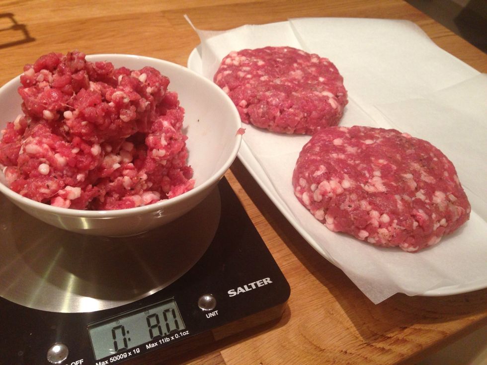 Measure 8 oz of meat, roll into ball shape and pat down into evenly sized burgers approximately 3/4 in. thick. Don't pat them too hard, but do smooth any large holes which will allow juices to leave.