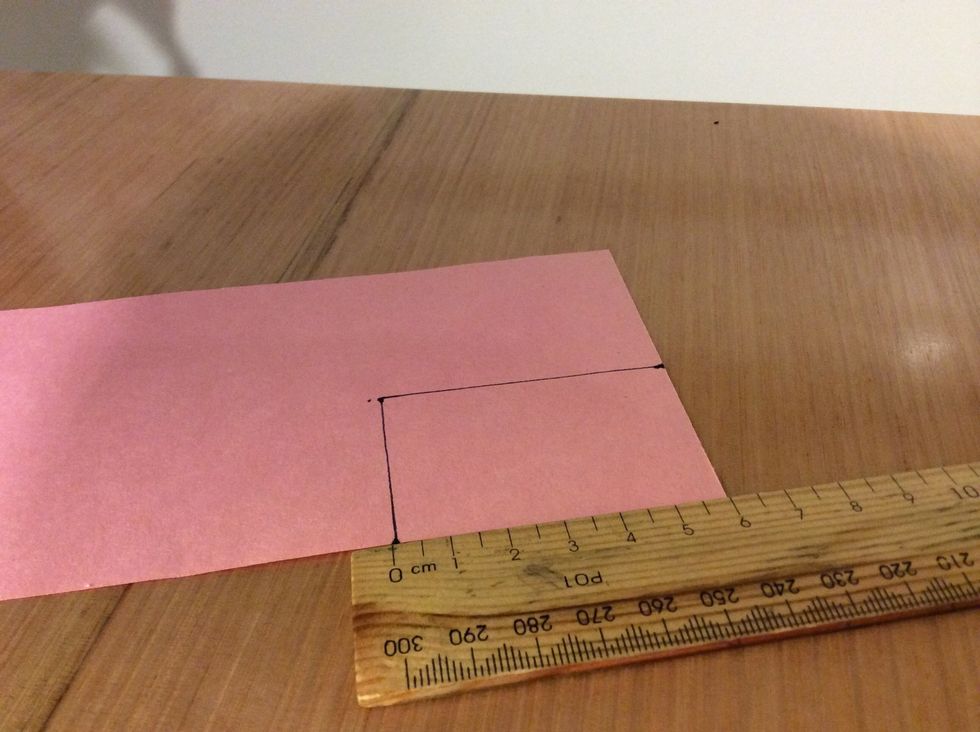 Measure a 4cm by 6cm rectangle on a piece of paper.