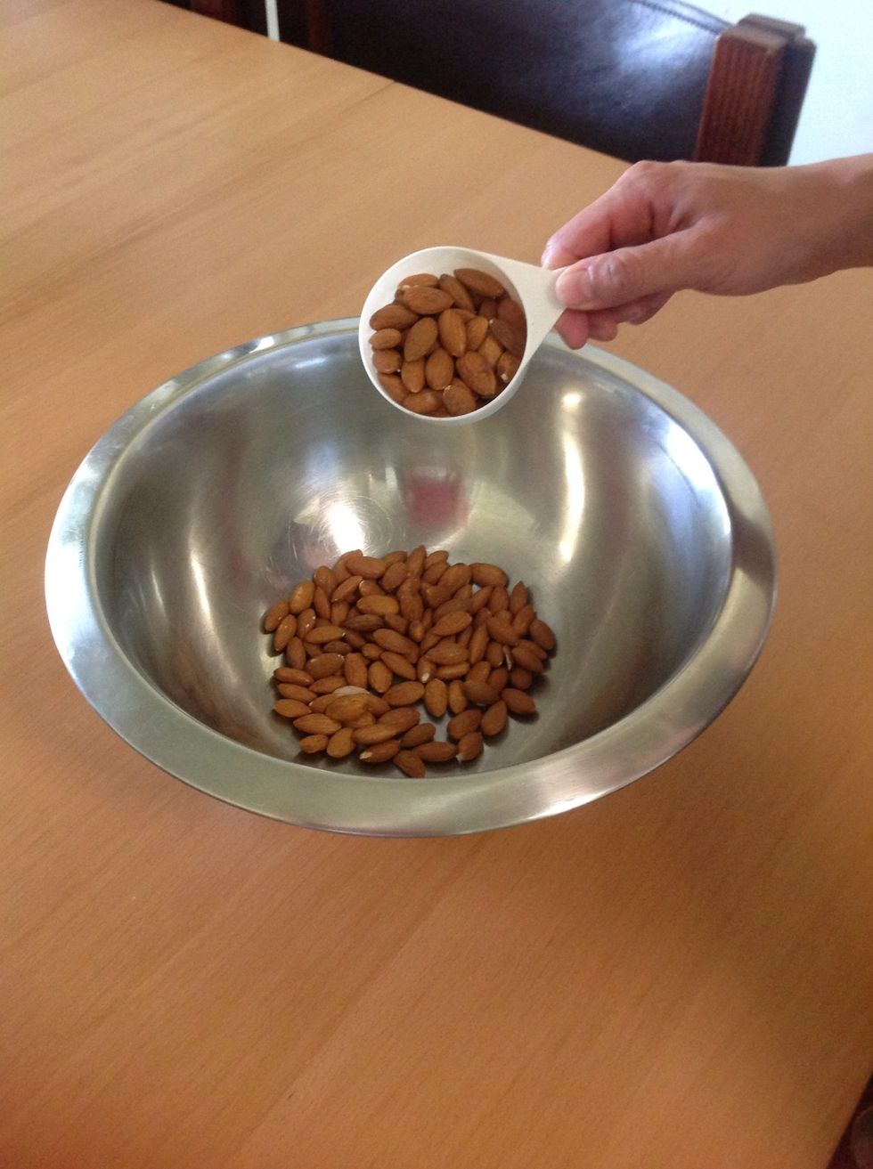 Measure a cupful of almonds (in Melbourne, 500g of almonds cost 10 dollars)...