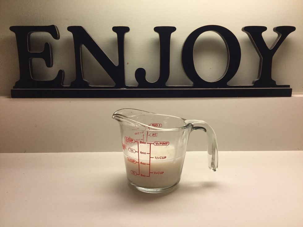 Measure a half a cup of unsweetened almond milk.