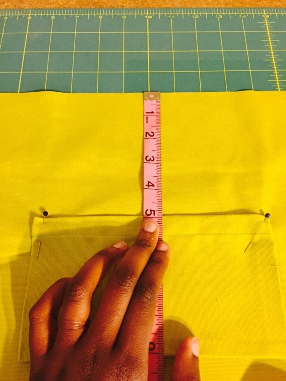 Measure about 5 inches from the top of your inner shell and place/pin pocket in the center.