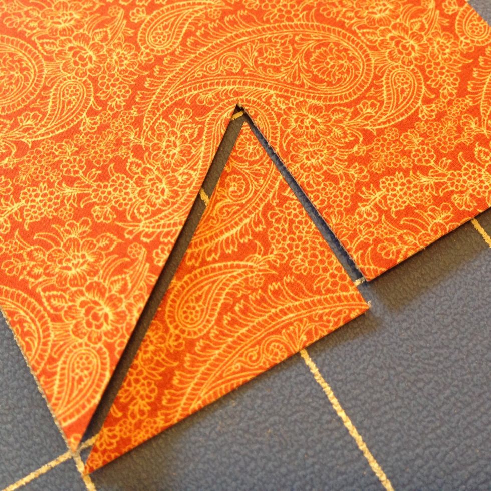 Measure and cut a line 1" into the center of both strips of paper.