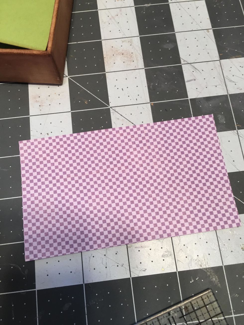 Measure and cut a piece of patterned paper to fit the inside bottom of the lid so that it shows when the tray is slid out. Attach with glue. (See the next photo.)