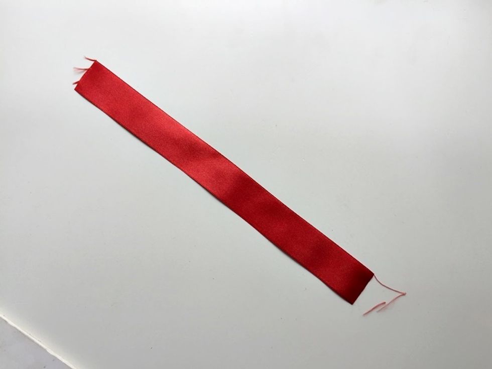 Measure and cut a piece of satin ribbon. I used 1 inch wide satin ribbons to make this flower. This ribbon should be around7-8 inches long.