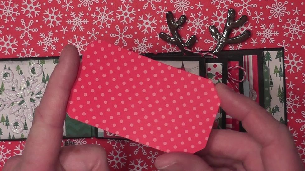 Measure and cut four pieces of decorative paper to create a tag to insert into the end of each page. Round the bottom corners and angle cut the top corners. Cut the tags they extend out 1/4".