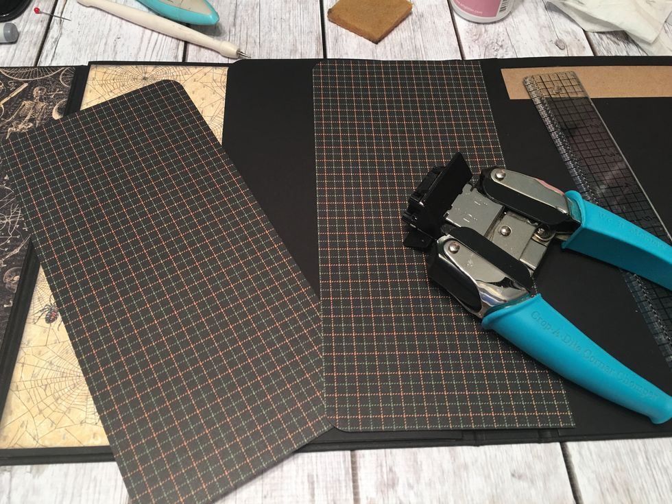 Measure and cut patterned paper to cover the front and the back of the flap.  Attach with glue.  Be sure to punch the corners of the papers to match up the corners of the flap.
