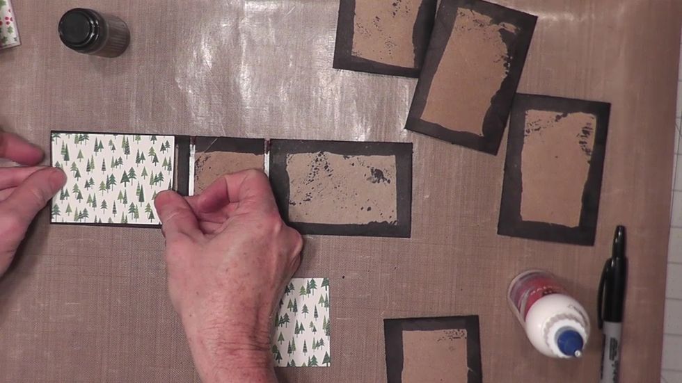 Measure and cut three pieces of decorative papers to pattern the front and back covers and spine area on the inside of the album.