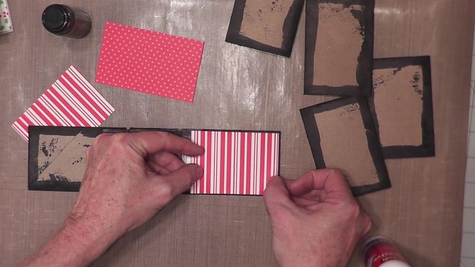 Measure and cut three pieces of decorative papers to pattern the front and back covers and the spine section on the outside of your album.