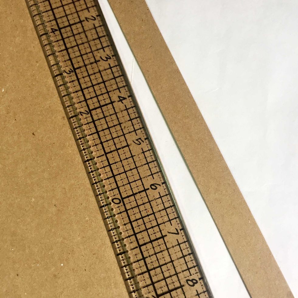 Measure and trim a 3/4" wide of strip from the thin cardboard/chipboard. This will be the rim of the lid.